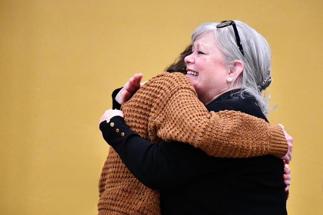Two people embracing at the Changemaker award ceremony.
